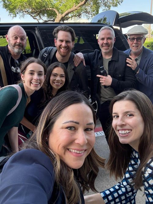 Group photo of Moon Rabbit Employees traveling and gathered around a car