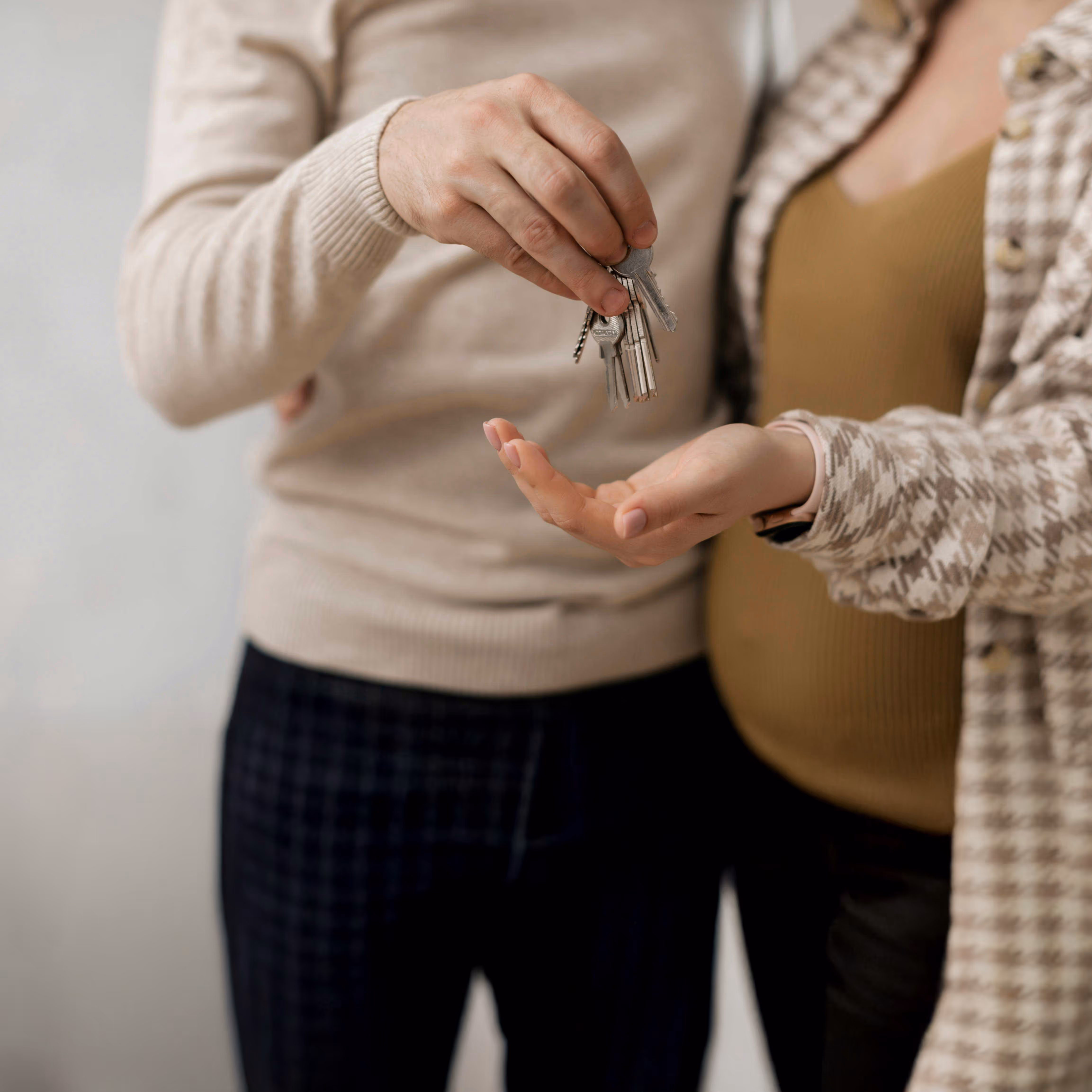 A young couple holding house keys