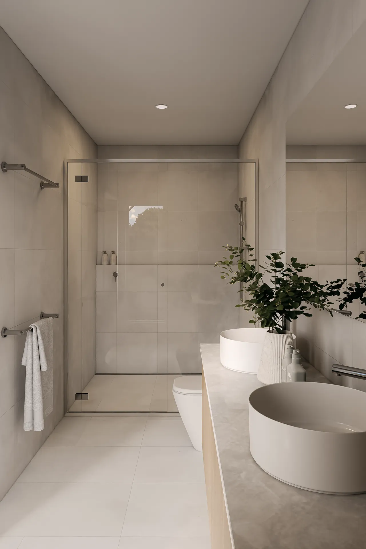 Row of modern two-story townhouses with garages, large windows, trees, and green lawn in front under a blue sky.