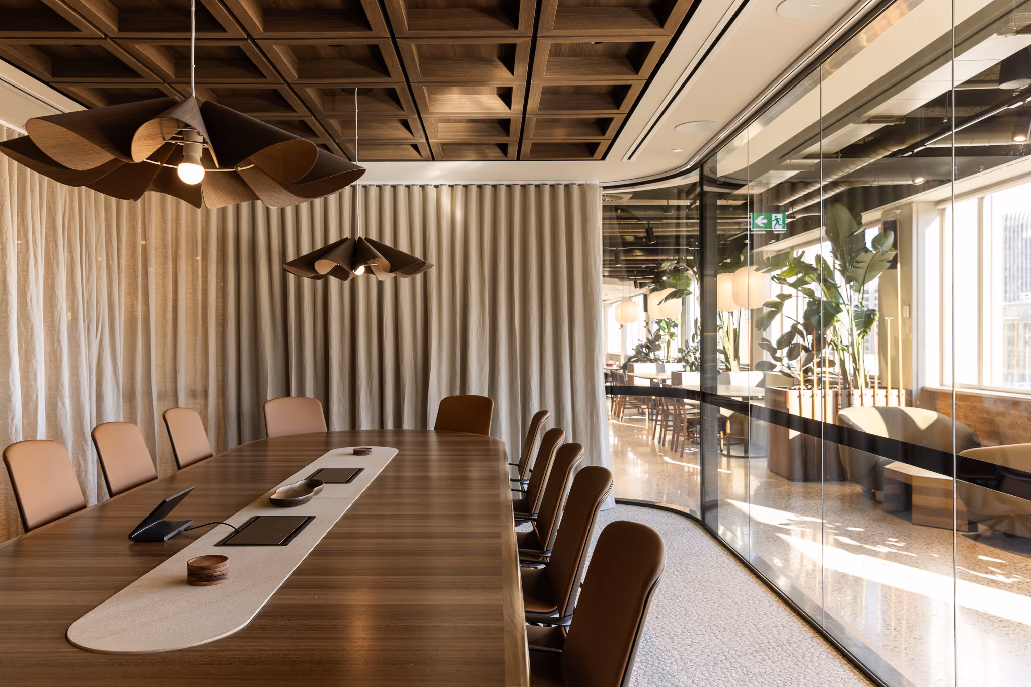 A modern workplace with round architectural features, bench seating, and large windows.