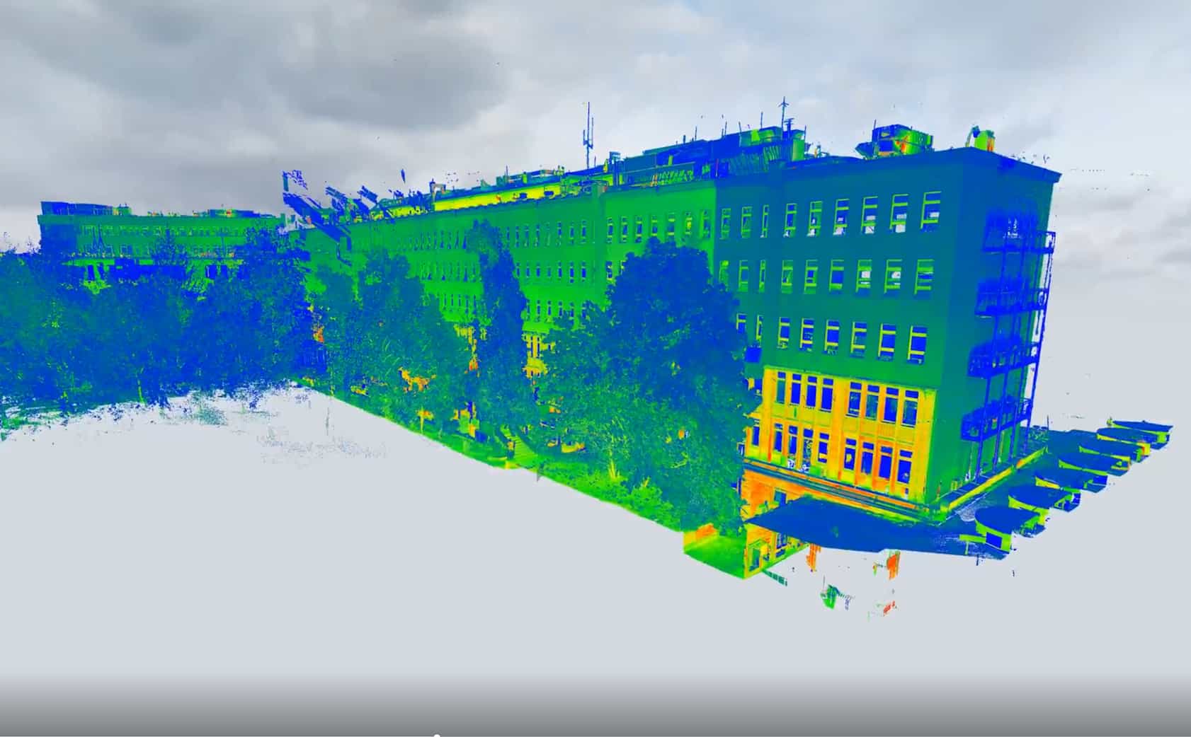 Laser-scanned 3D model of a hospital exterior in color, showing building geometry and adjacent greenery.