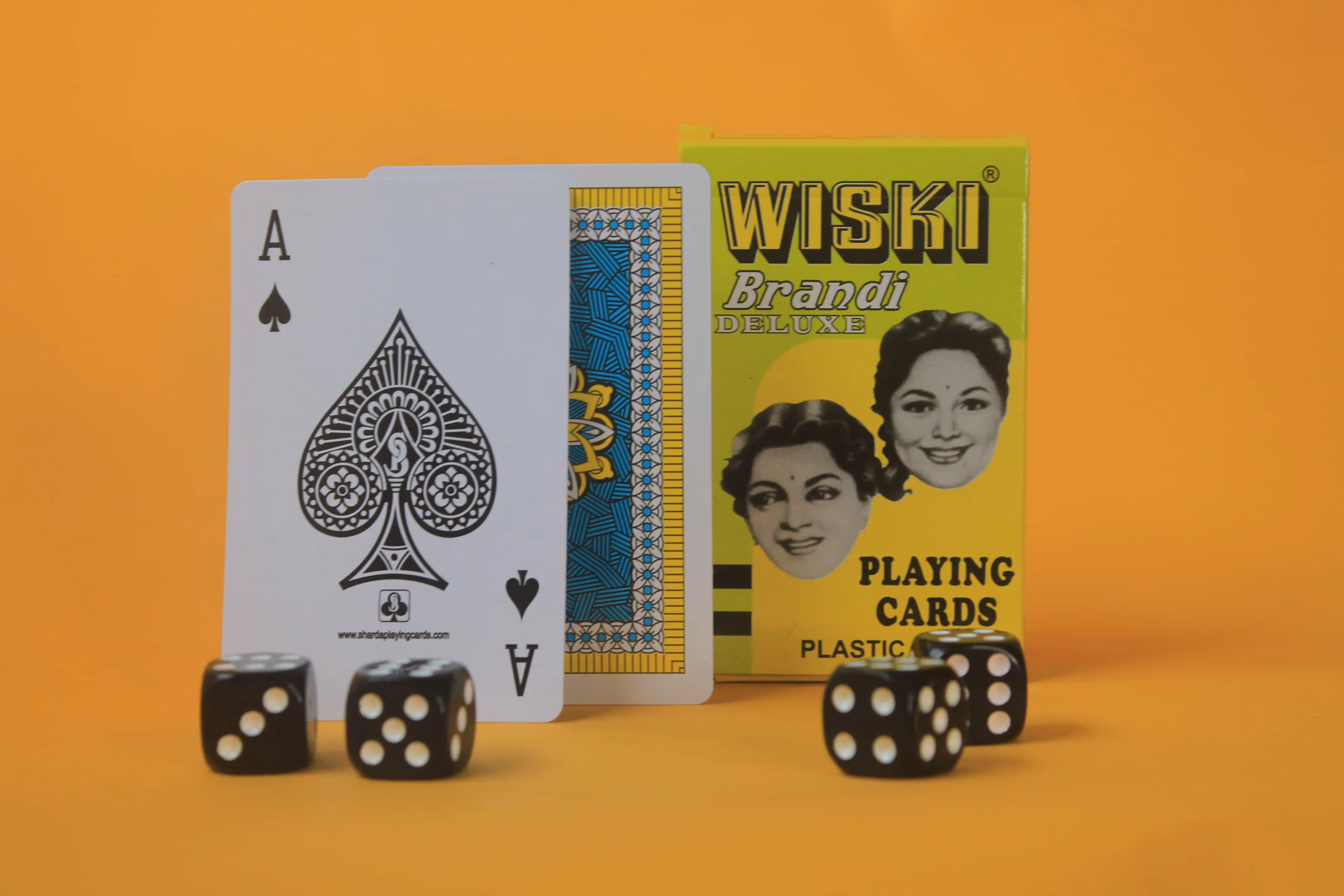 Wiski Brandi deck displayed upright against a neutral background, showcasing its bold yellow tuck box and vintage charm.