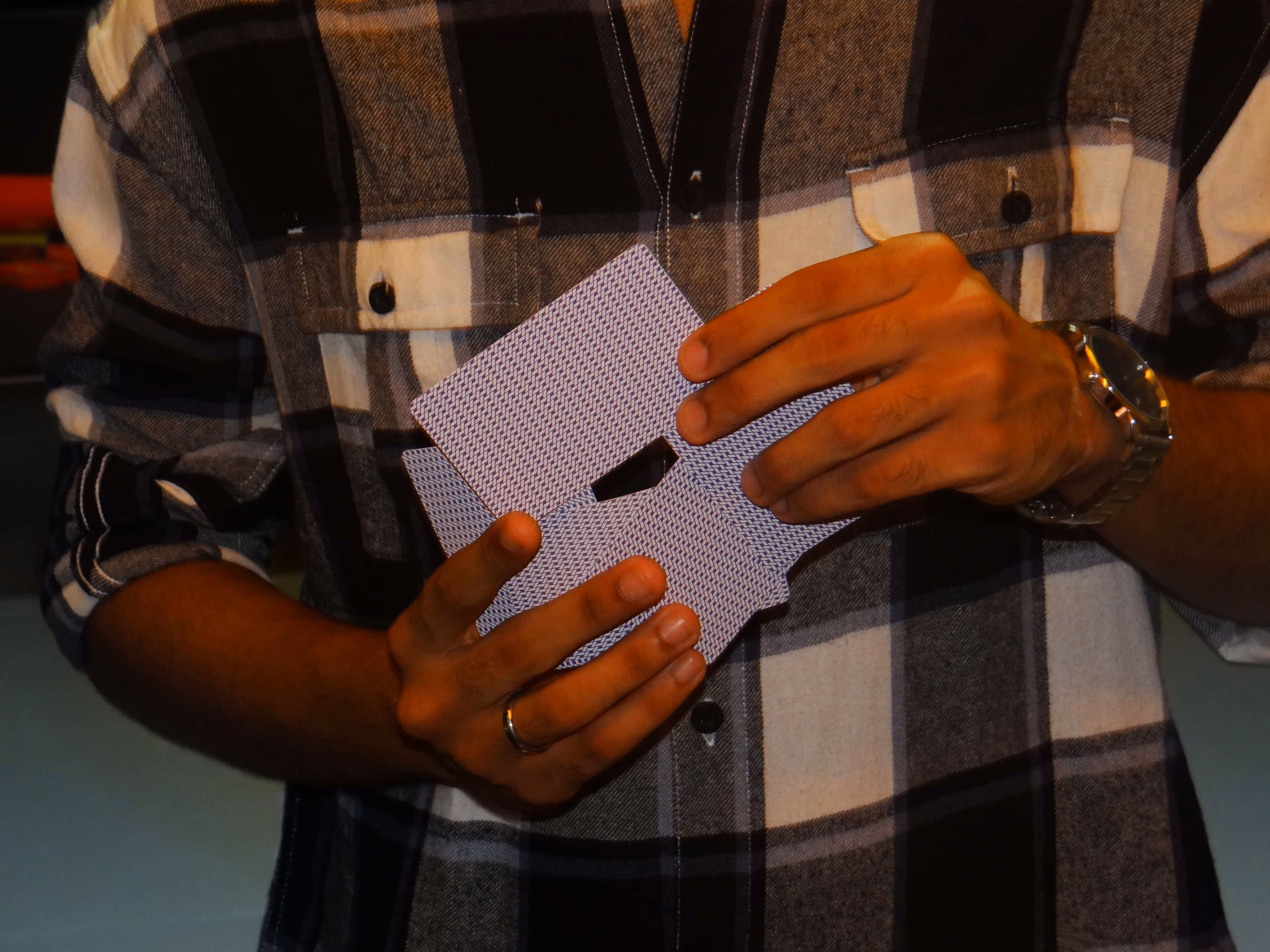 A close-up of Great Mogul cards being fanned in hand, revealing elegant back patterns.