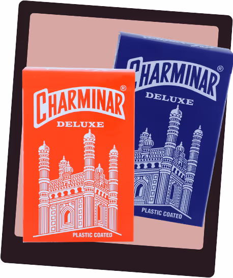 Red and blue Charminar tuck boxes side by side, showcasing their minimal layout and heritage-inspired detailing.