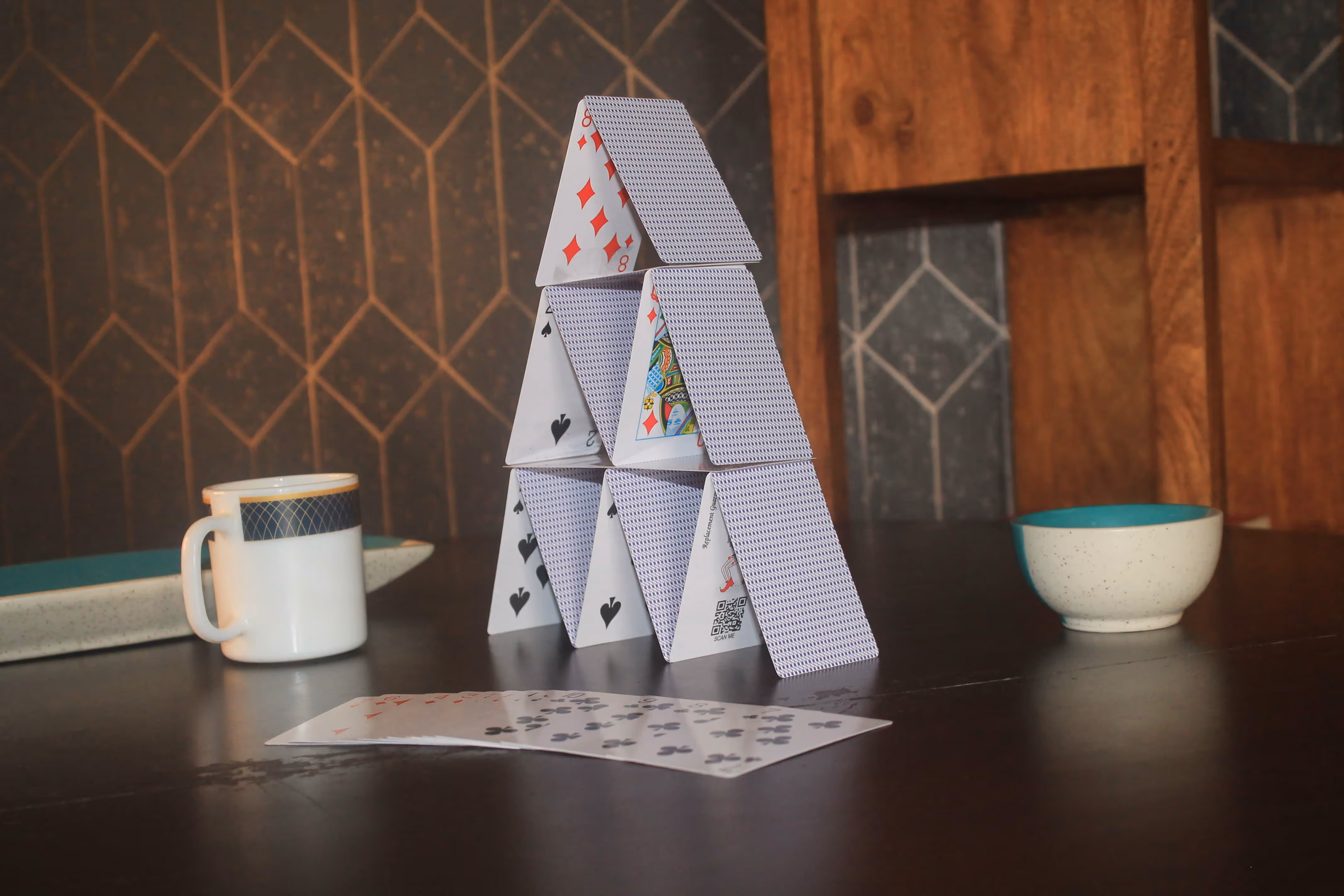 Shot of Great Mogul cards being arranged in a house of cards format, revealing elegant back patterns.