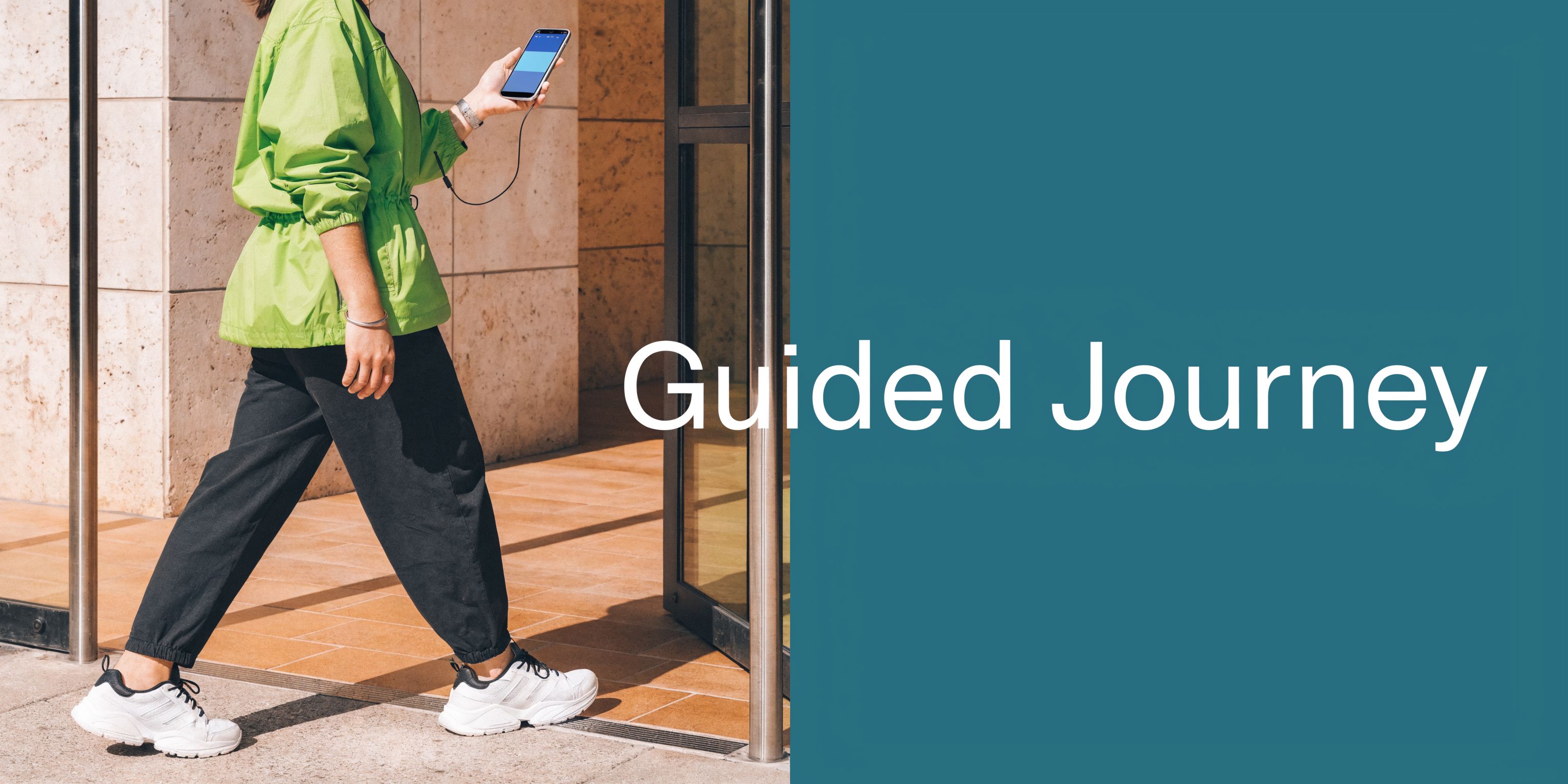 A visually impaired person walks through a door while using a smartphone with a navigation app.