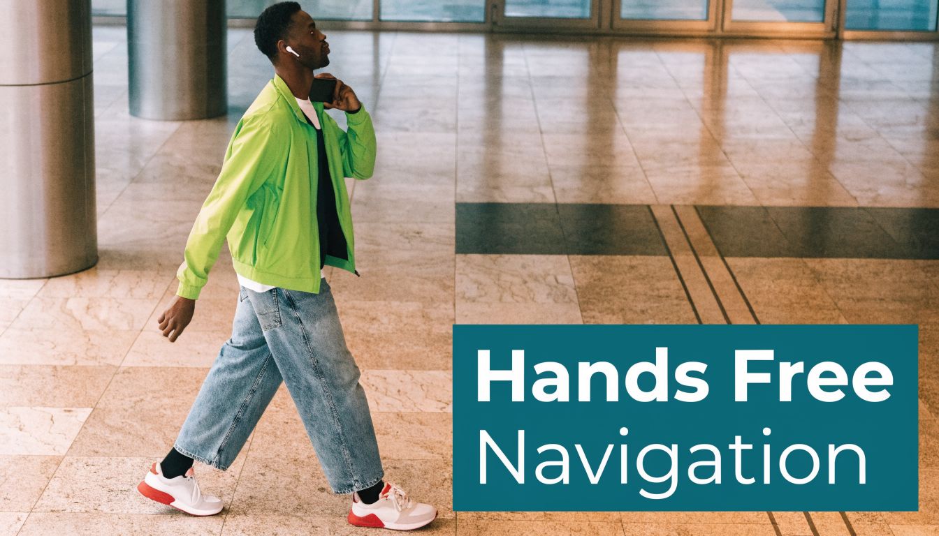 A young man walking through a bright indoor lobby using wireless earbuds for hands free navigation