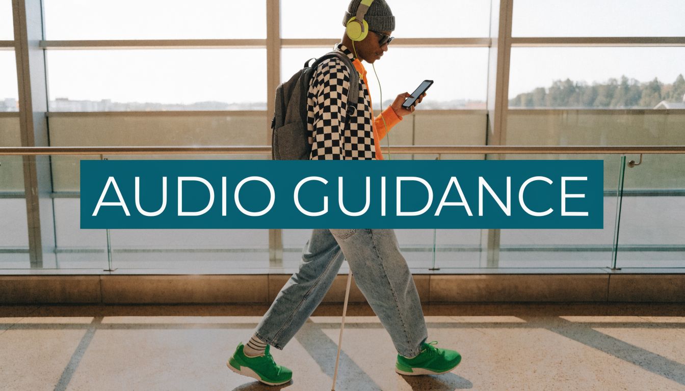 A young visually impaired person walking through an airport terminal using a white cane and headphones.