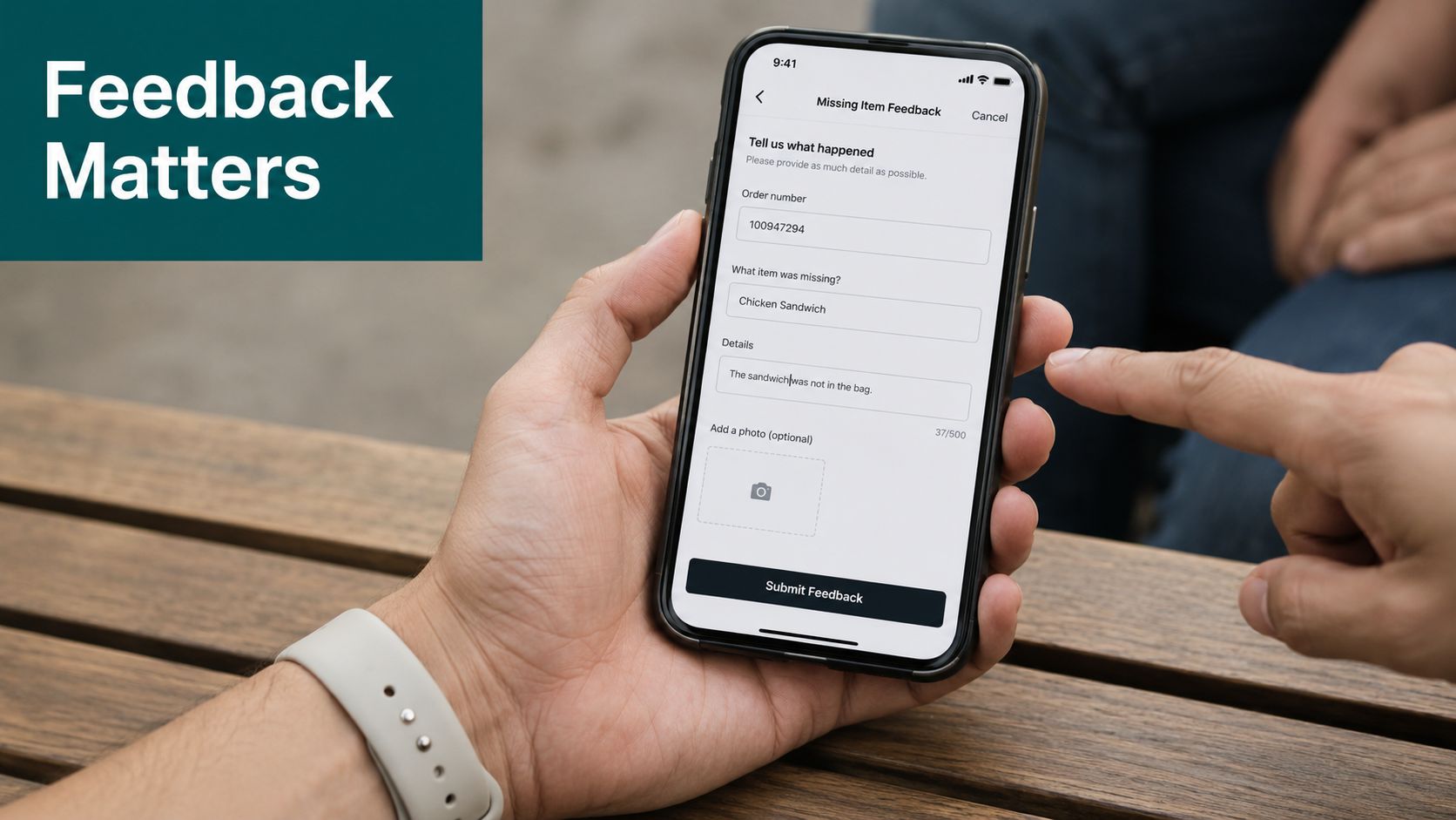 A person holding a smartphone showing a missing item feedback form to report a restaurant order issue.