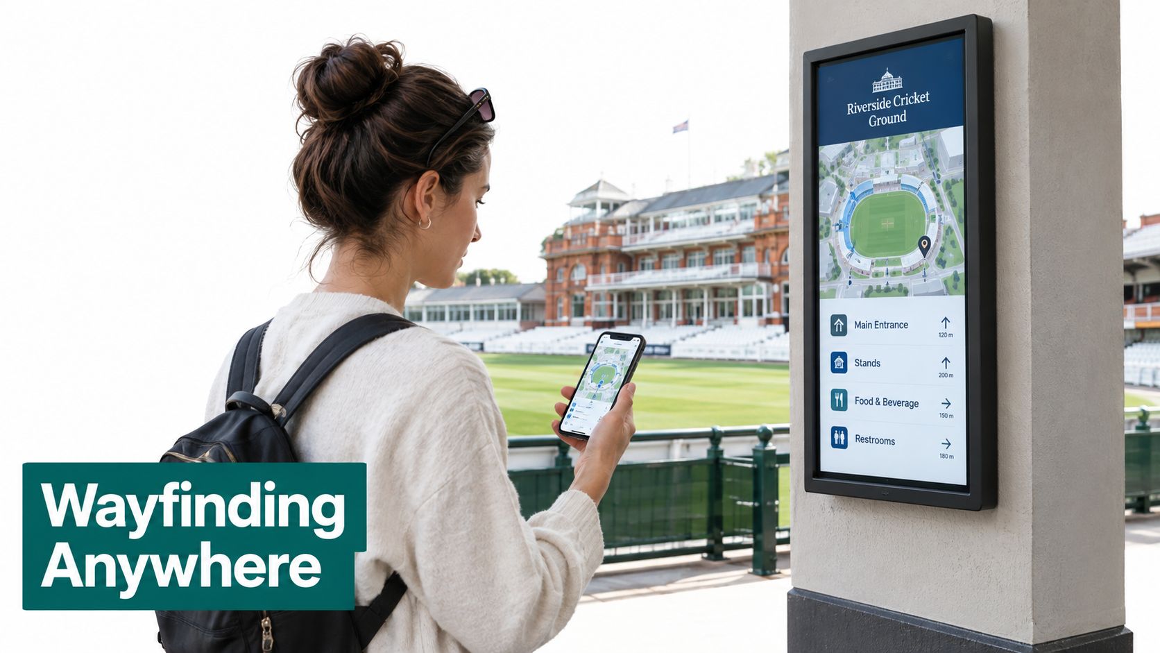 A young woman checks a cricket stadium map on her smartphone while standing next to a digital kiosk.