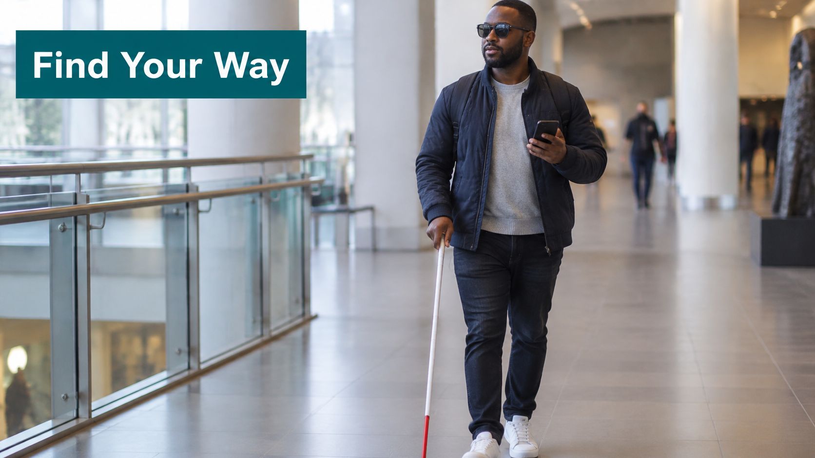 A visually impaired man with a white cane walking through a modern building holding a smartphone.