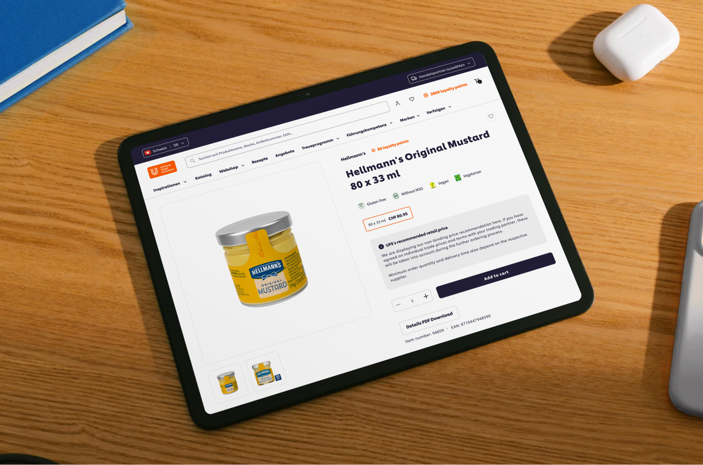 Unilever Food Solutions Webshop Tablet on wooden table displaying Hellmann's Original Mustard product page with price and details.