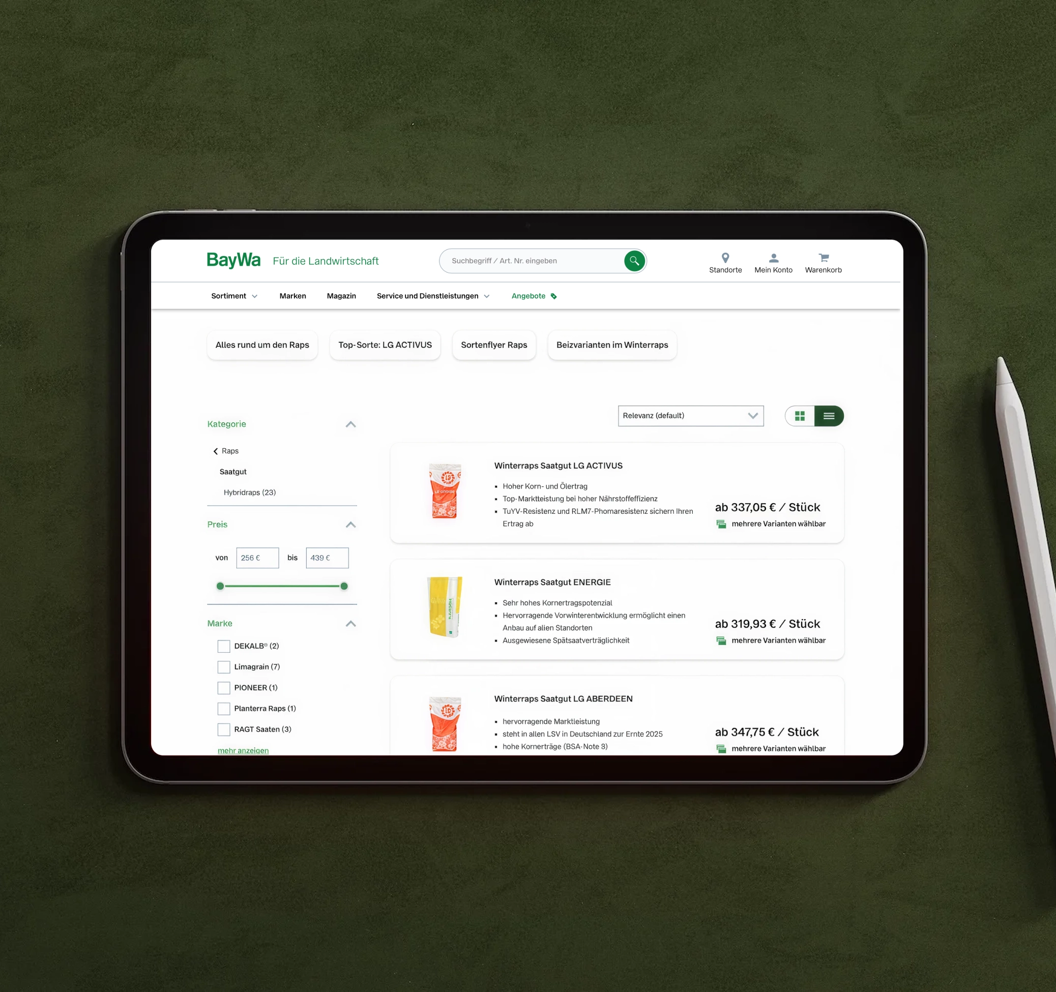Tablet on green surface showing BayWa online store collections page.