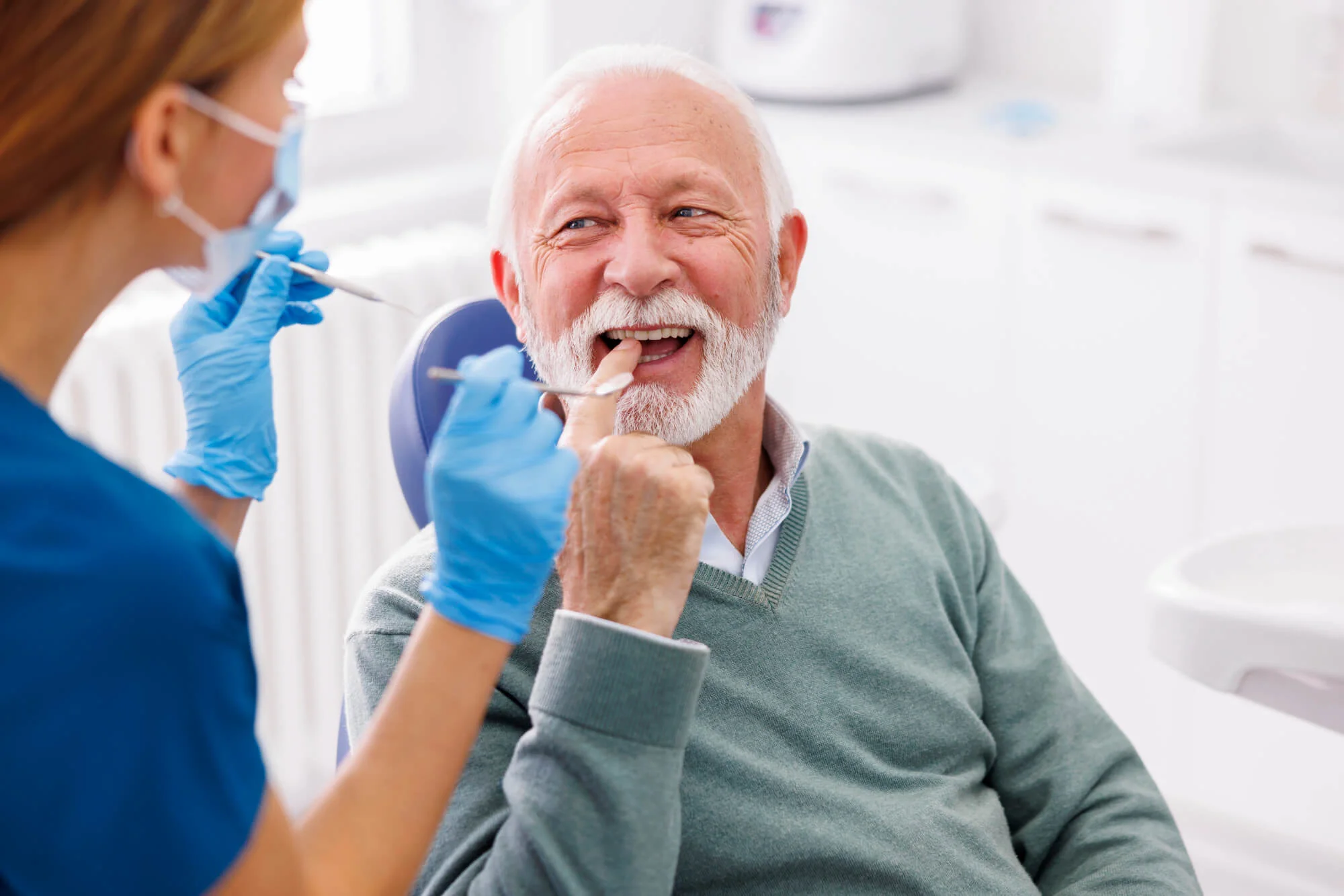 Dentist doing dental checkup on a patient for affordable dentures in Montgomery, AL.
