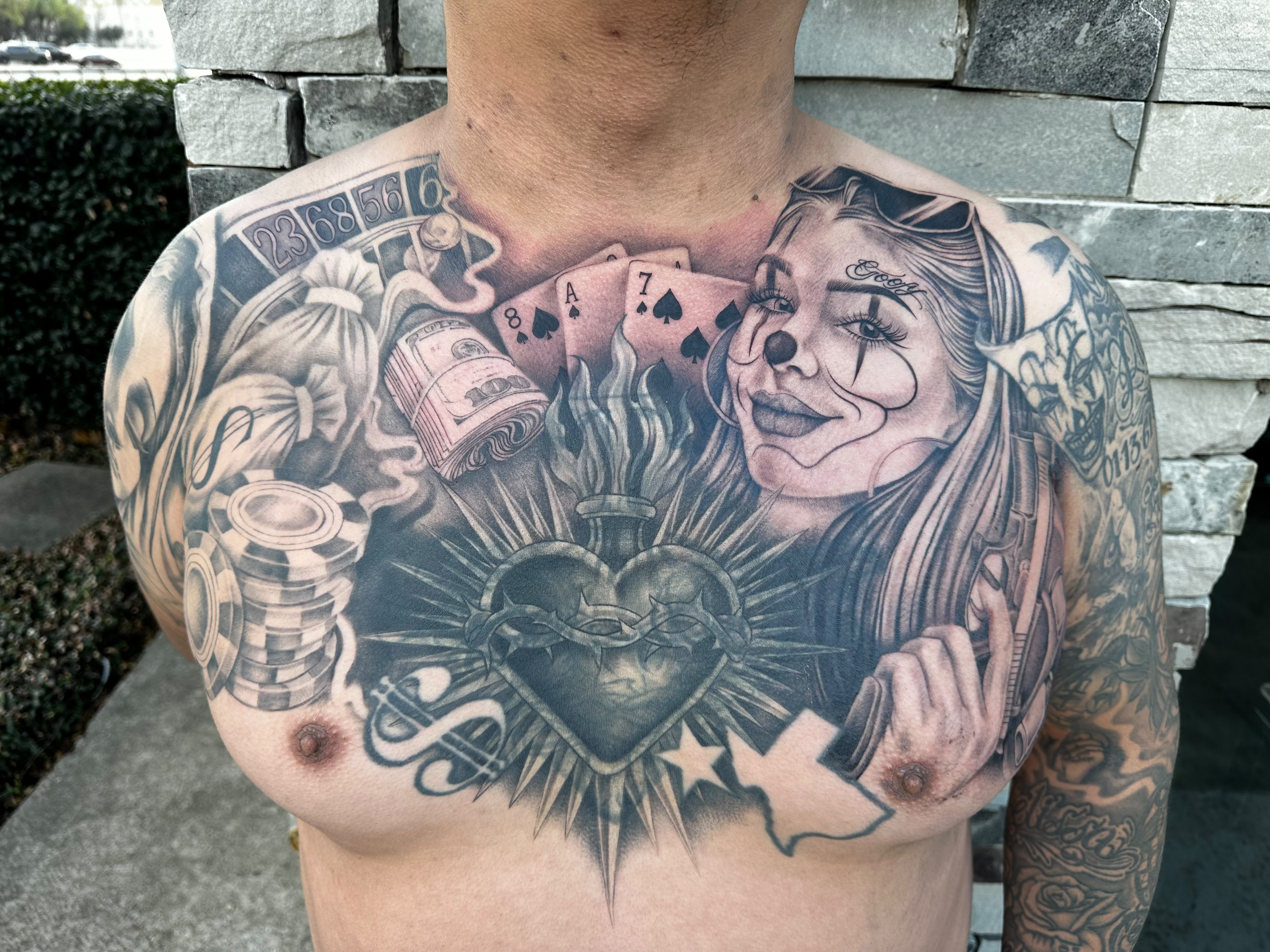 Black and grey gambling-themed full chest tattoo with sacred heart by Dani B, Fort Worth tattoo artist