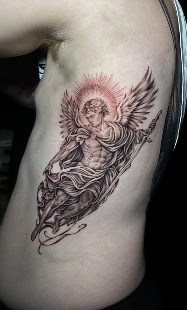 Freshly tattooed black and grey archangel rib piece with delicate linework by Dani B at Santana Studio Co