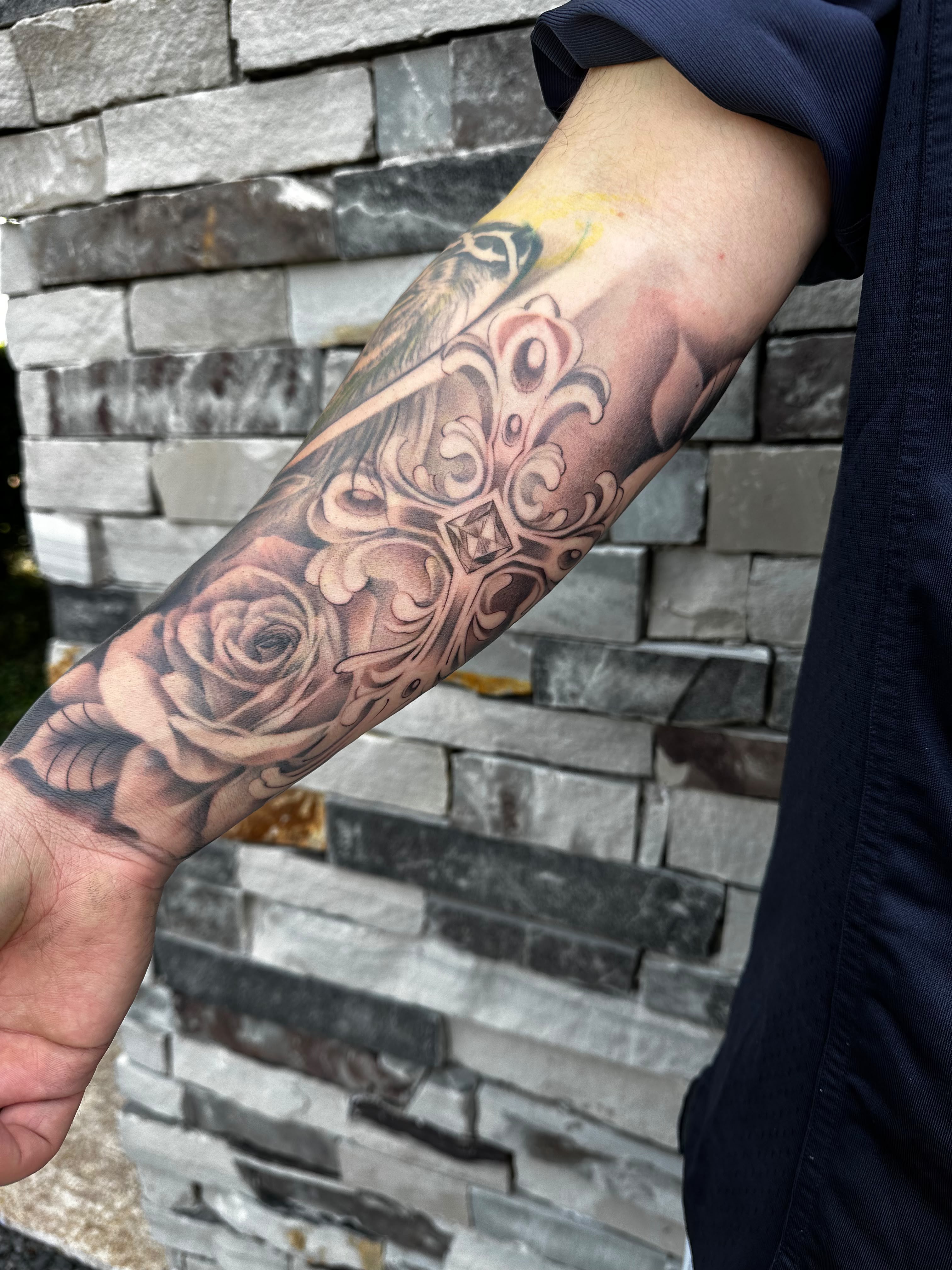 Rose and ornamental cross forearm sleeve tattoo by Dani B at Santana Studio Co