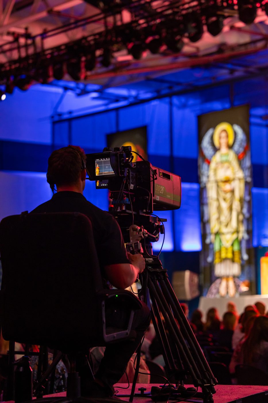 Broadcast camera operator capturing a live ceremony