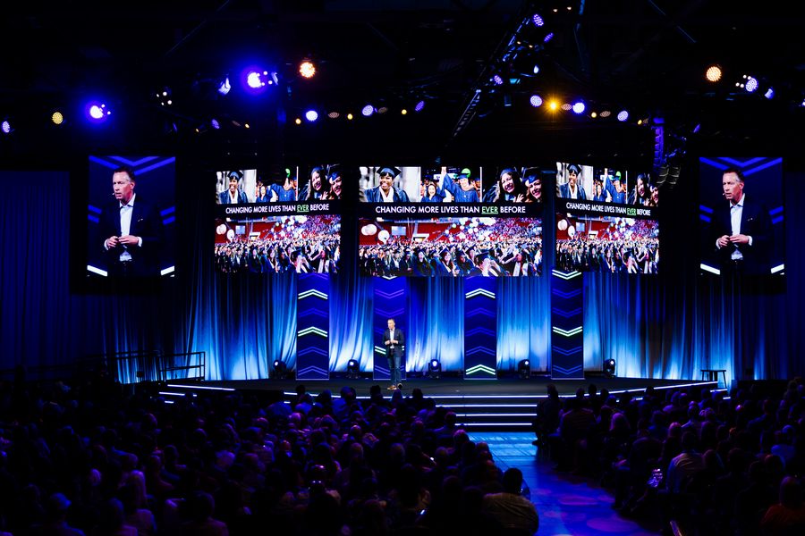 Speaker on the WGU main stage with large video screens