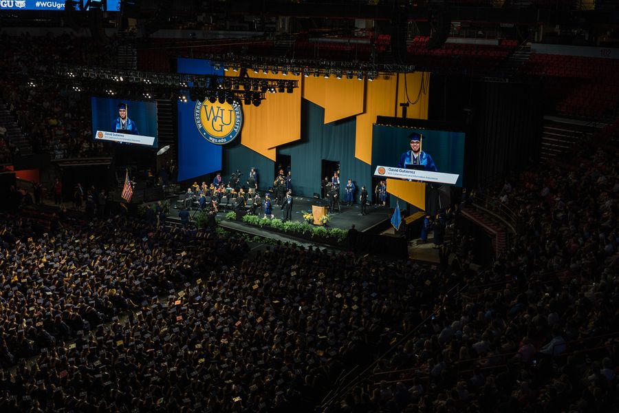 Graduate on the arena IMAG screens at WGU commencement