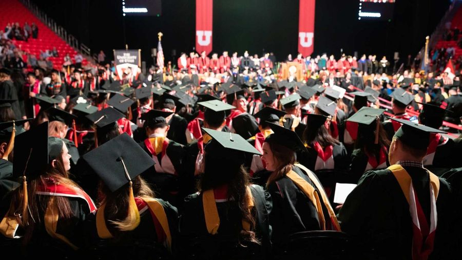 University of Utah graduates seated in the arena during commencement