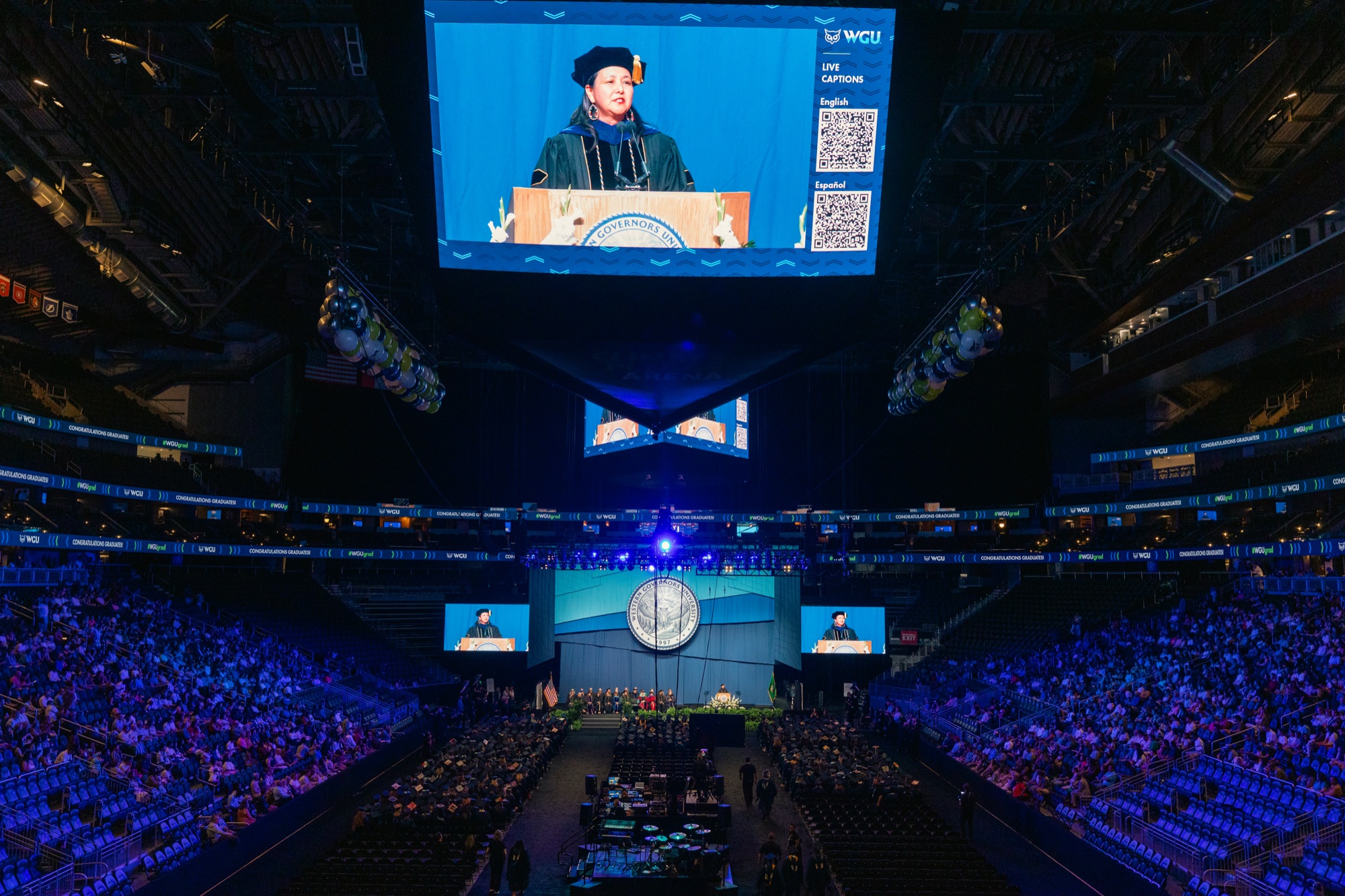 Arena jumbotron with live captions in English and Spanish