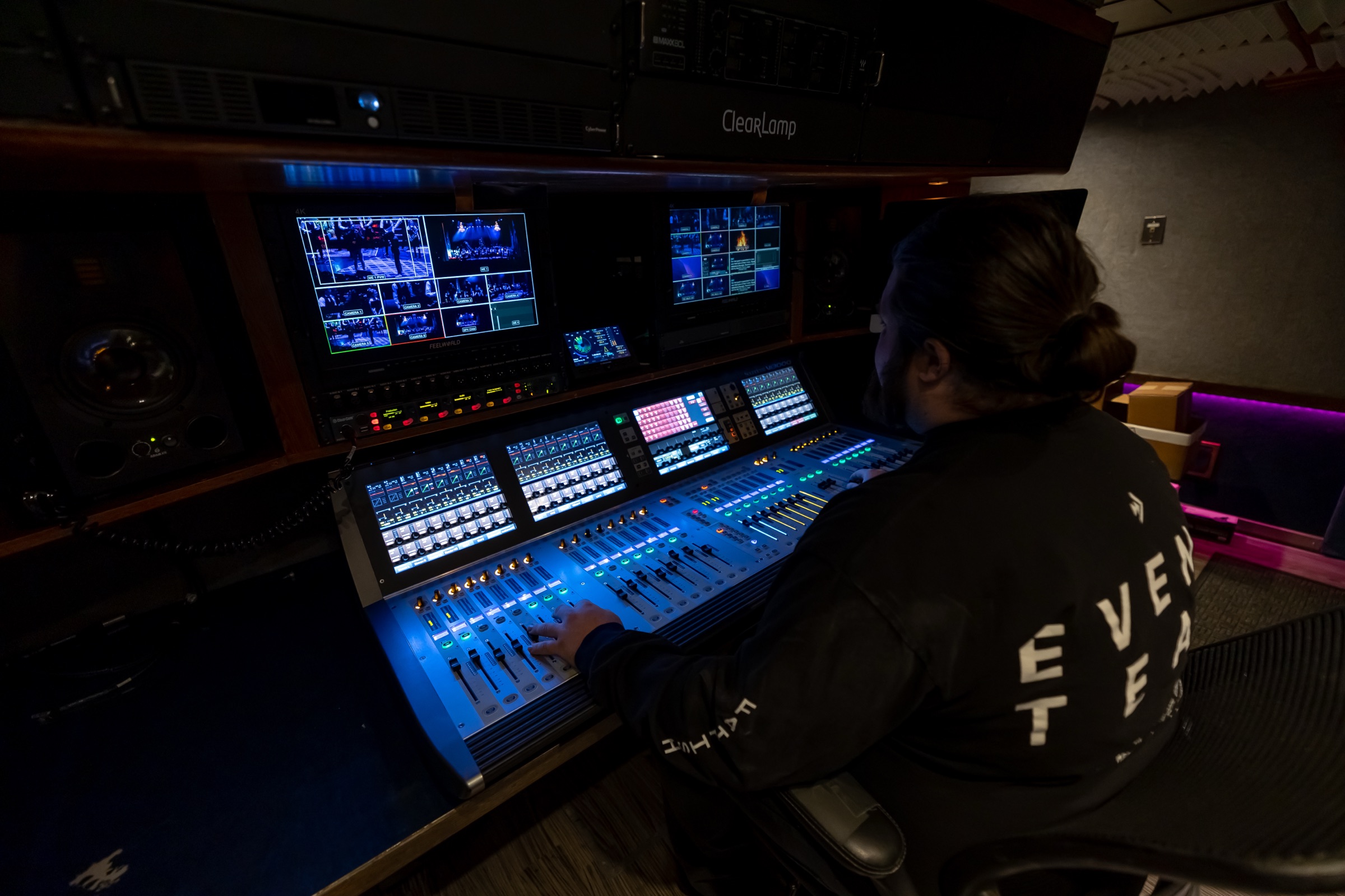 Audio engineer mixing on a digital console in the large truck's isolated audio booth