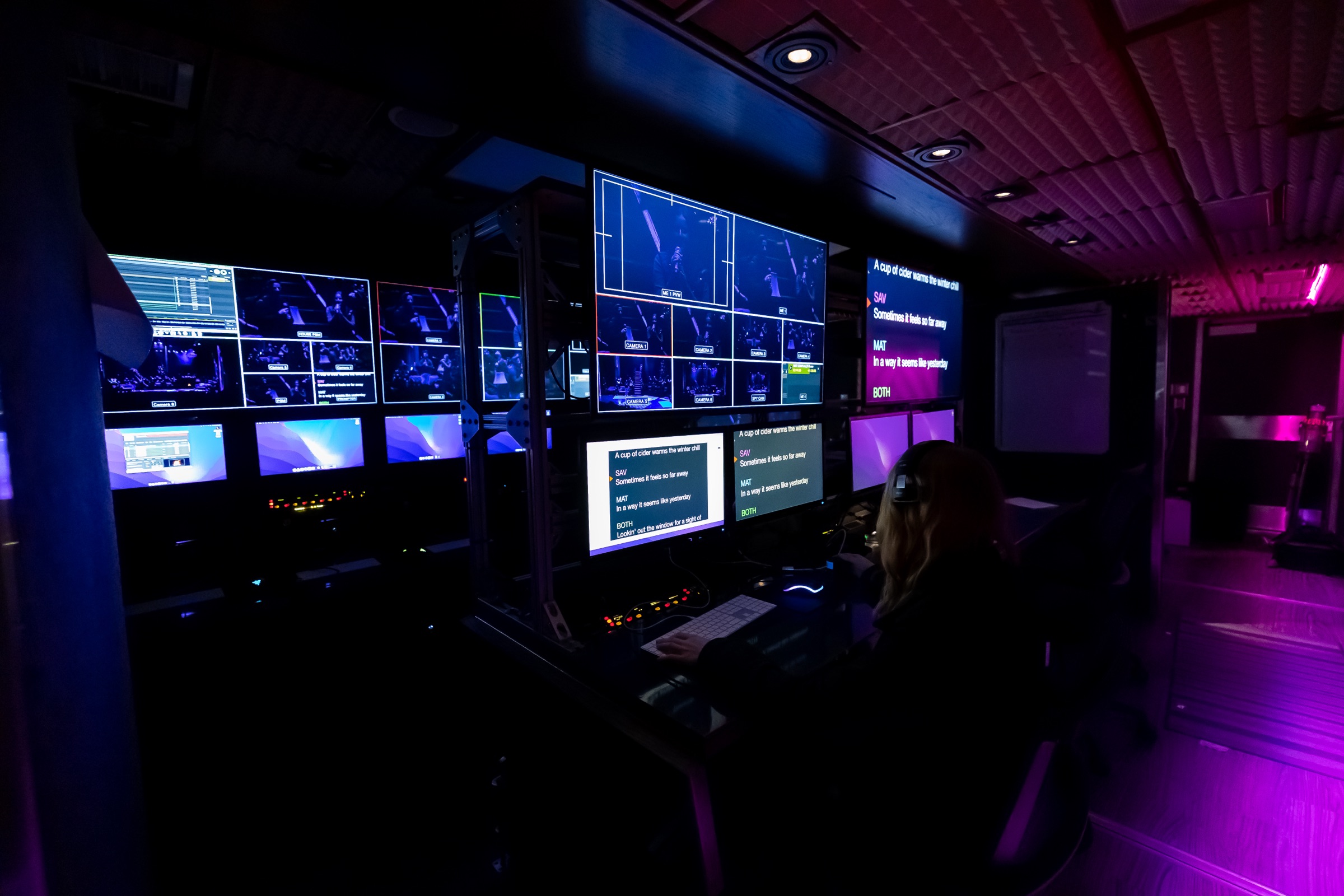 Teleprompter and show-caller station in the large truck, script and camera feeds on screen