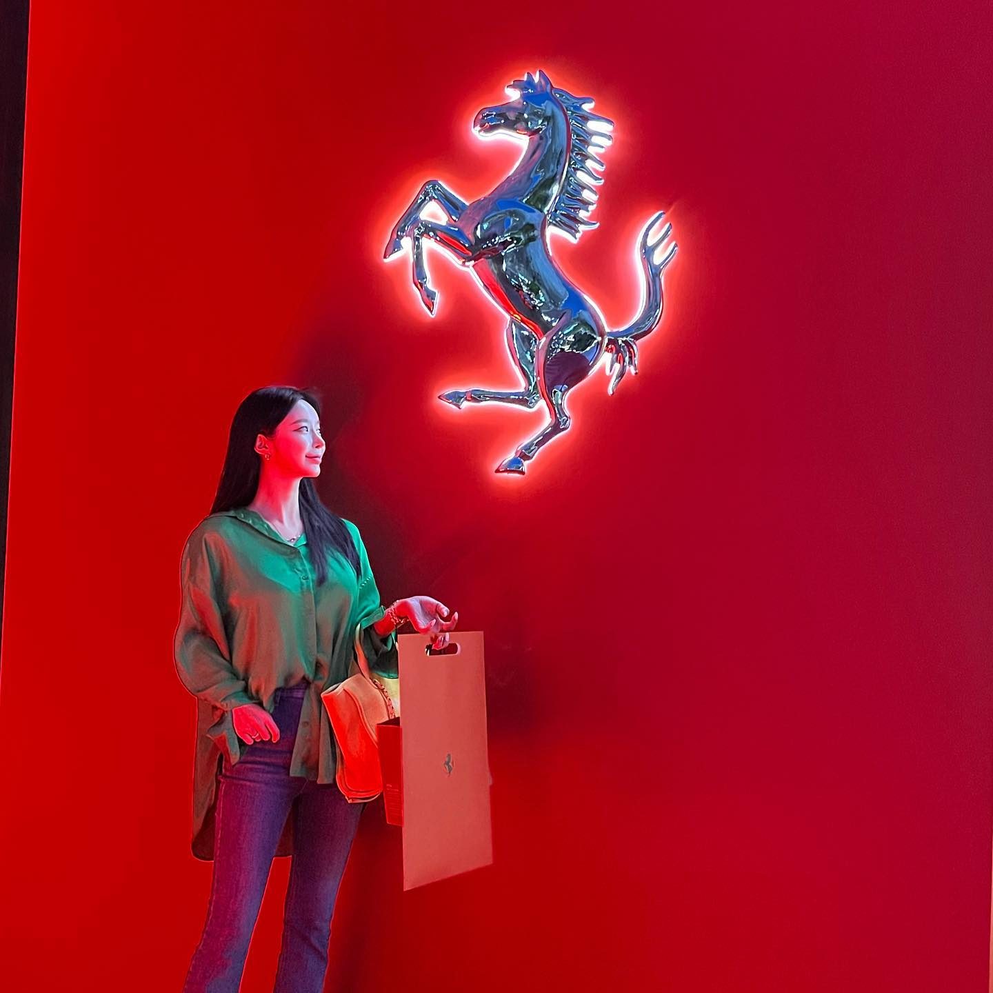 Chrome Cavallino on Red Wall with Guest