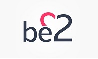 Logo, jossa tekstinä 'be2', numero 2 on yhdistetty sydämen muotoiseen muotoiluun pinkillä värillä. 