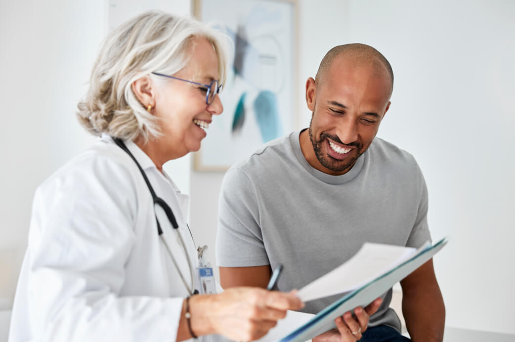 Woman looking at receipt and laptop