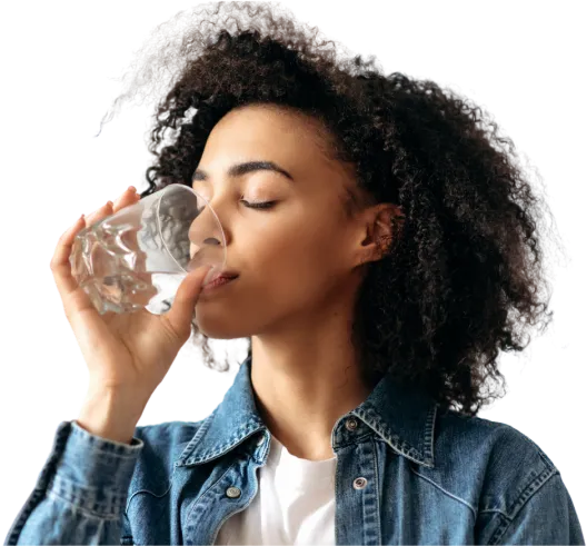 A woman drinking a glass of water.