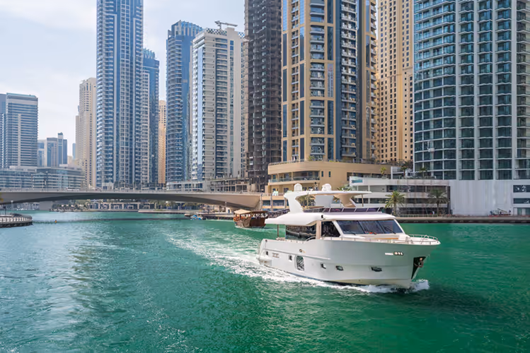 Skyscrapers in the backdrop of a luxury yacht docked at Dubai Marina. The lifestyle that BSO landlords enjoy with fully managed rental and property services.