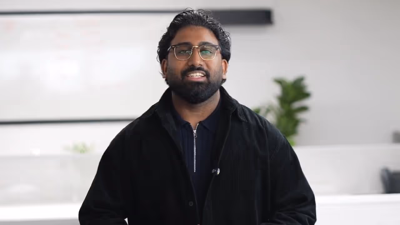 A professional man in glasses and a dark jacket speaks to the camera, representing the various specialized services offered by property maintenance companies in Dubai.