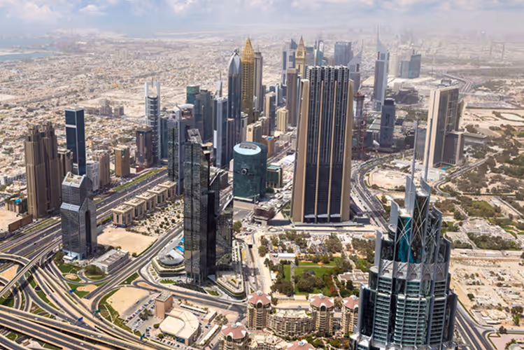 Aerial view of modern skyscrapers and highways in Downtown Dubai. Stunning skyline of Downtown Dubai, showcasing the city’s real estate and commercial infrastructure potential.