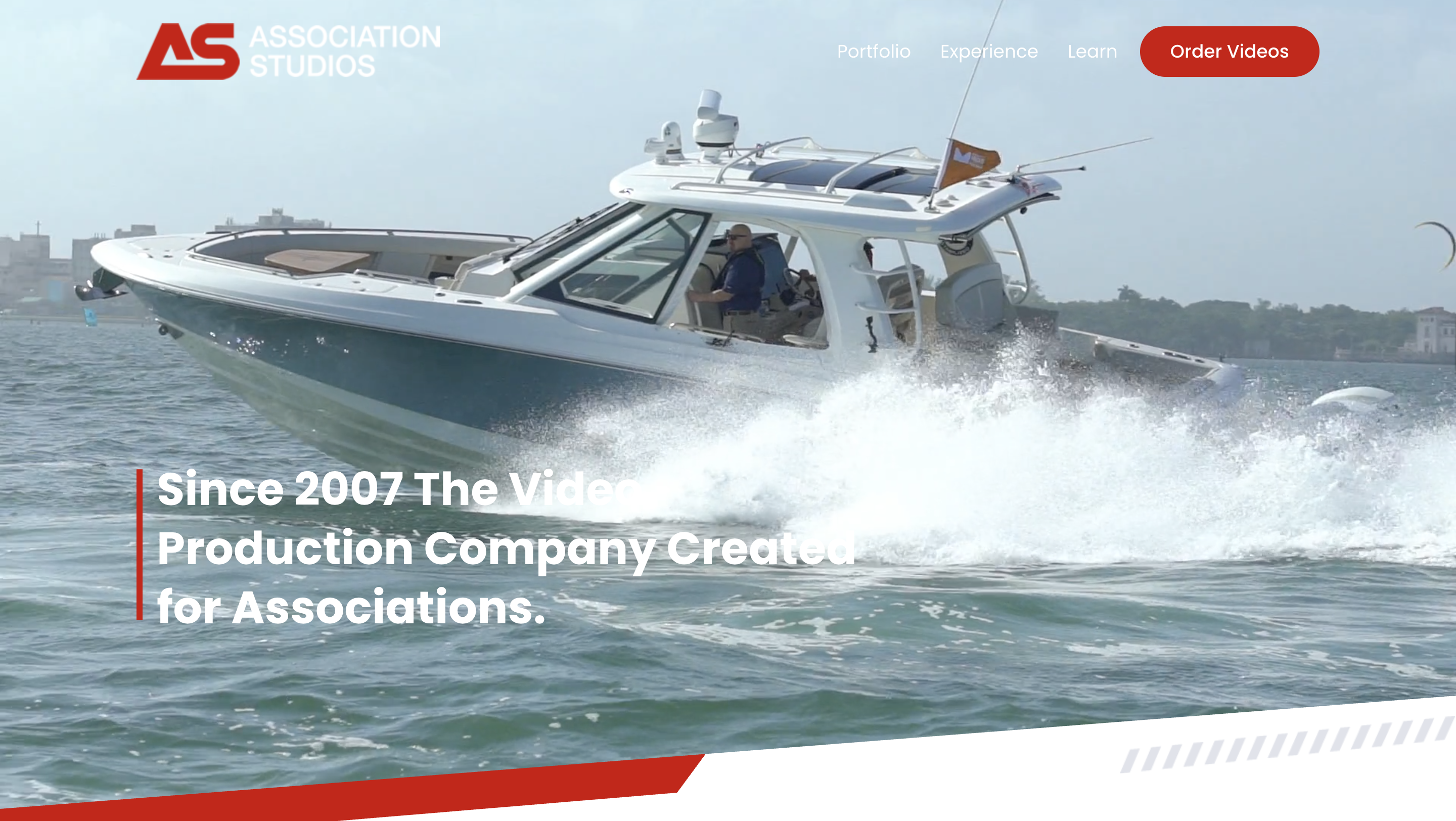 Association Studios filming a high-end boat video on open water with professional camera crew and equipment.