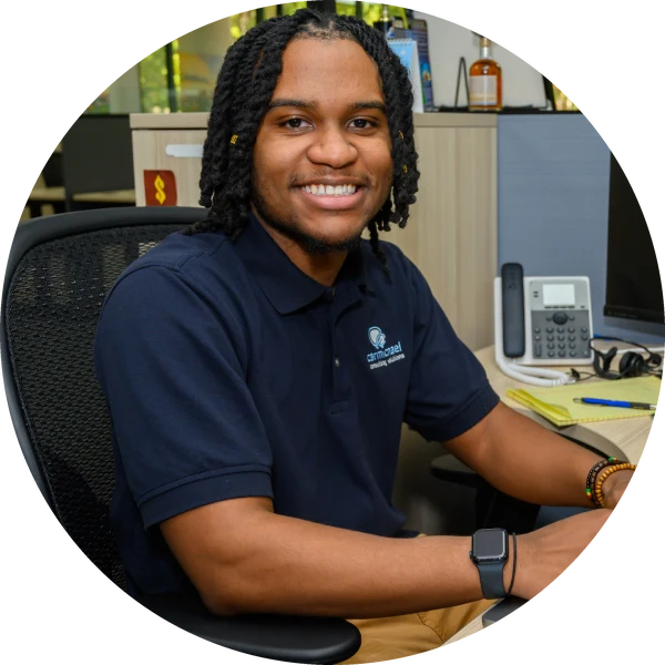 Carmichael technician smiling at his desk