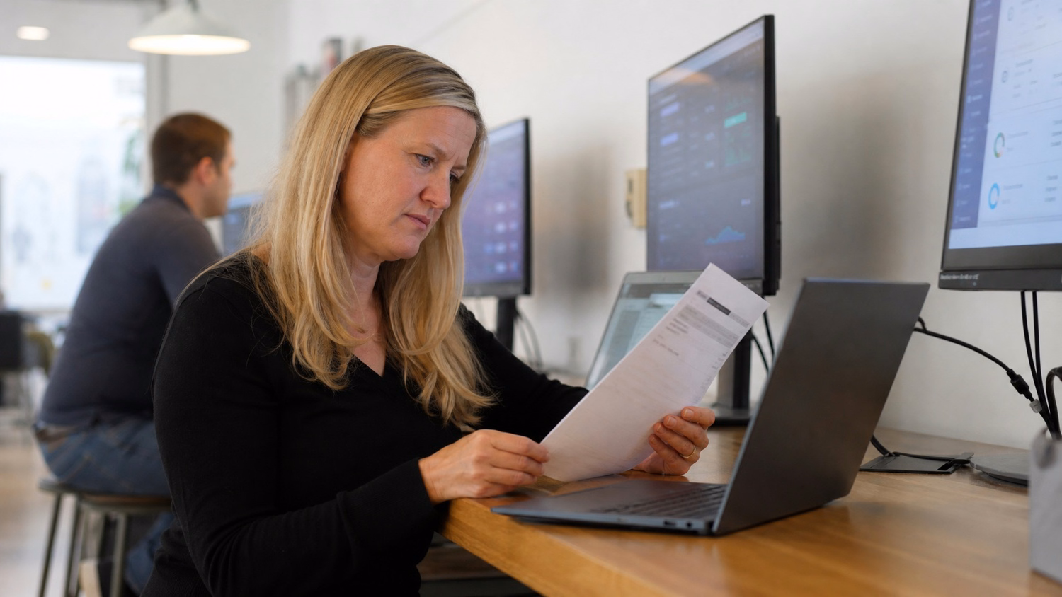 Woman analyzes suspicious email at standing desk 45