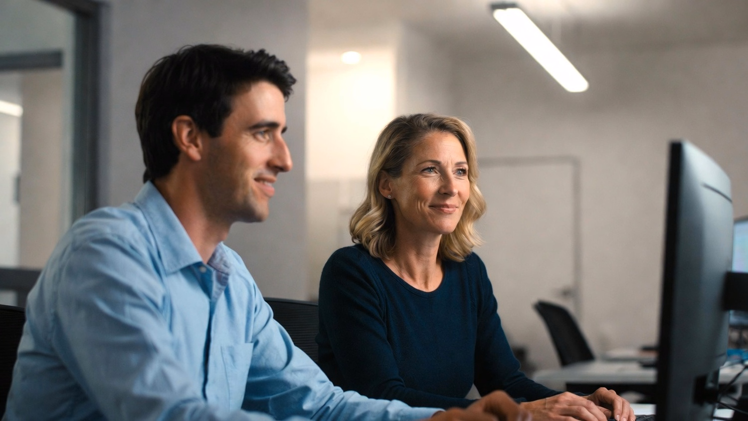 Colleagues discuss cloud solutions in office corridor 58 chars