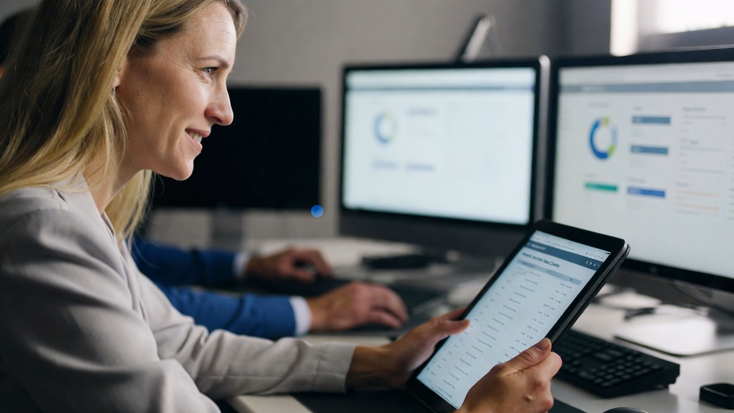 Woman reviews digital version control log on tablet 57 chars