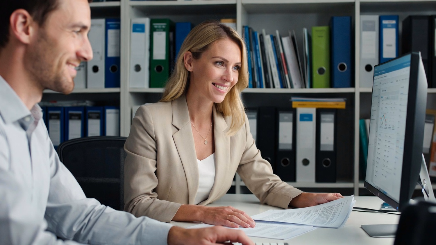 Woman reviews project documents by technical bookshelf 62