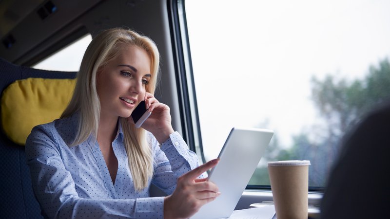 A woman working while commuting to work