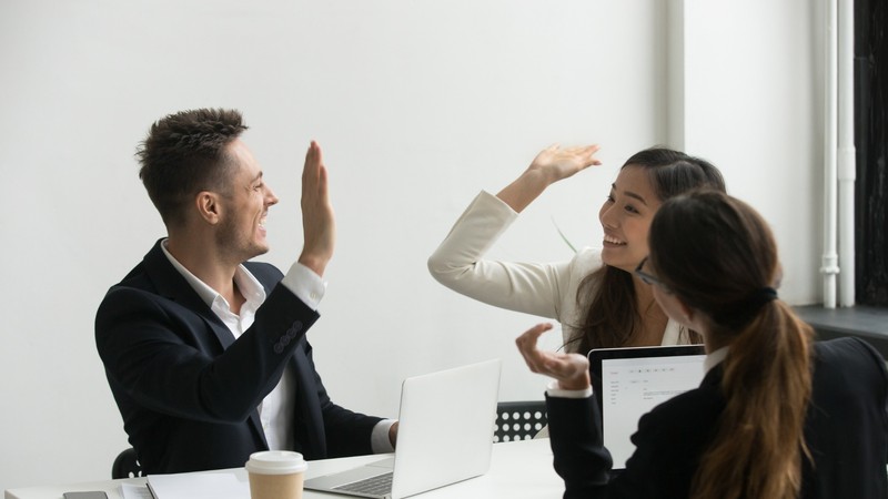 Colleagues celebrating clearer priorities and fewer meetings