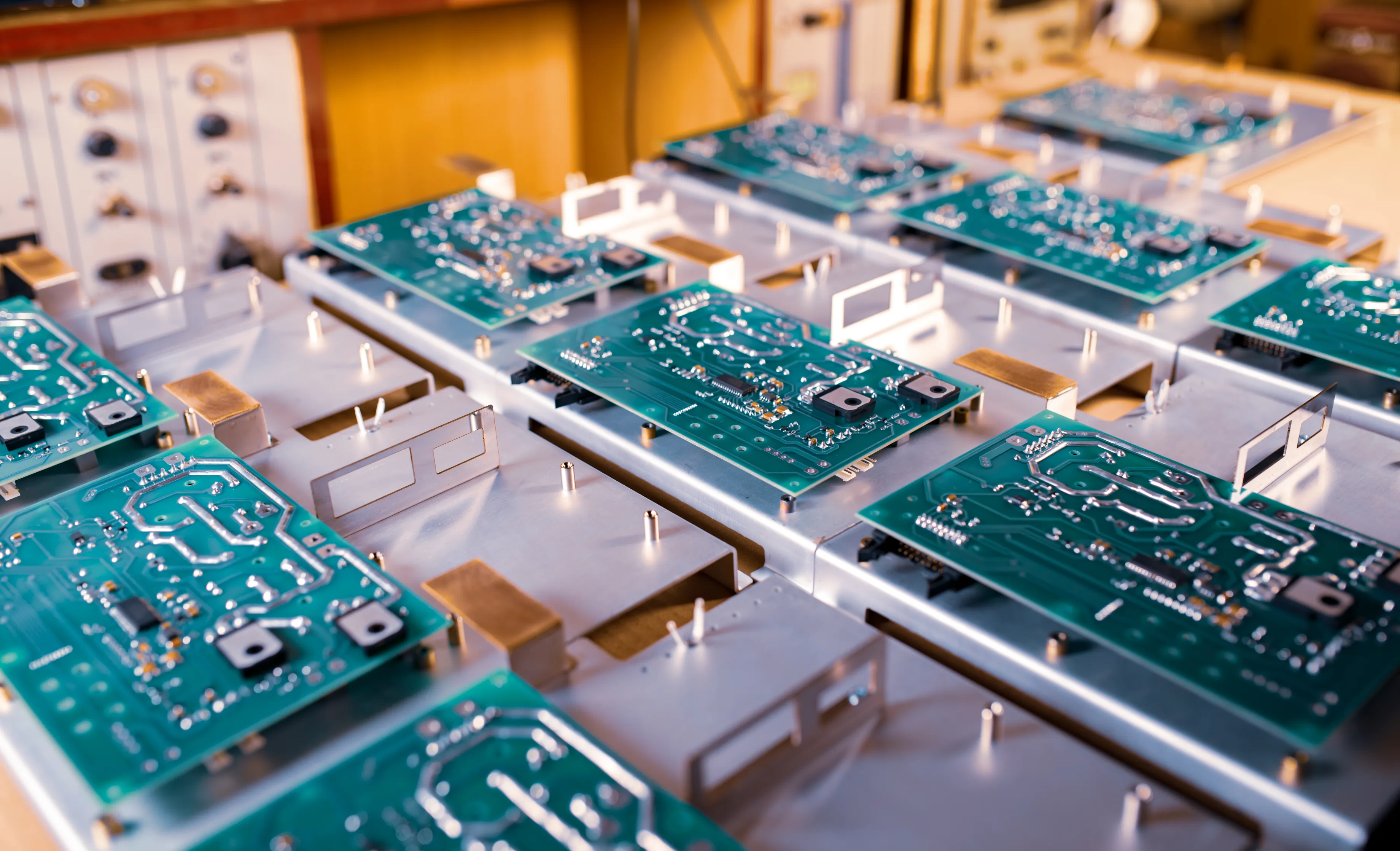 A row of circuit boards undergoing the prototype PCB assembly process, with components being placed and soldered as part of a production trial. This phase allows manufacturers to test designs before moving into full-scale production.