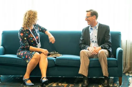 Two business people talking on a couch