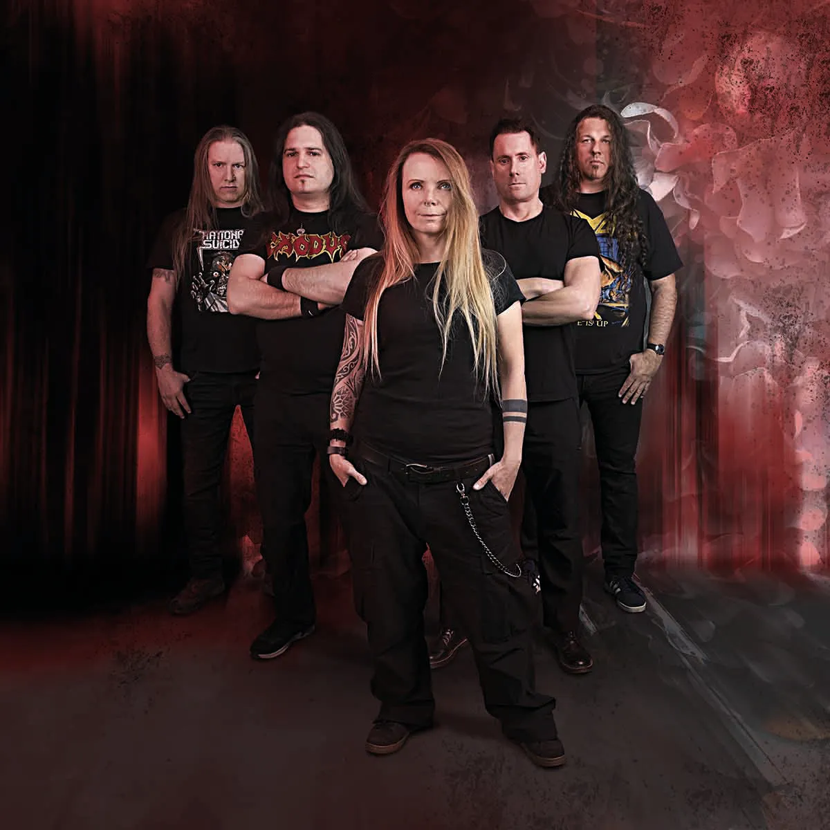 Five men standing against a wall wearing black jackets and dark pants, posing for a group photo. BAND: ILLDISPOSED