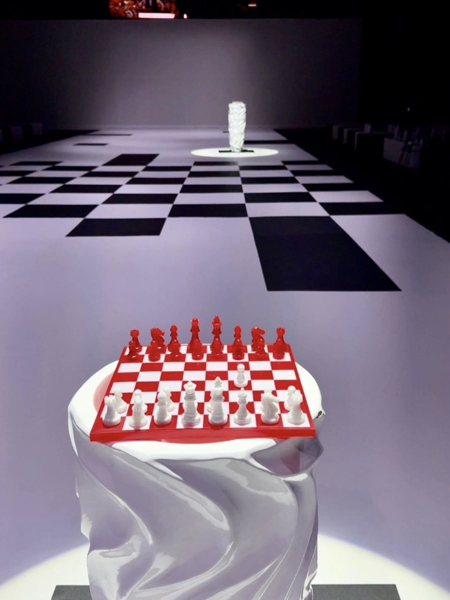 Handmade red and white FERZ chess board on a sculpted pedestal on the runway