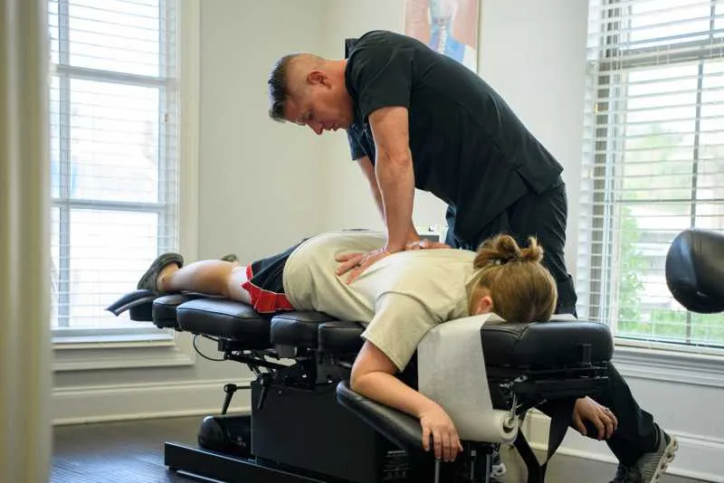 Baton Rouge chiropractor, Dr. Scott LeBlanc, giving a chiropractic adjustment to a patient.