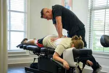 Baton Rouge chiropractor, Dr. Scott LeBlanc, giving a chiropractic adjustment to a patient.