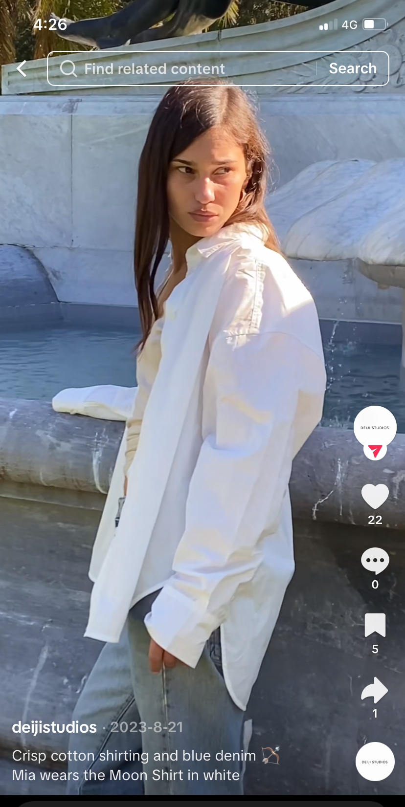 Female model stand by fountain with white cotton shirt in TikTok